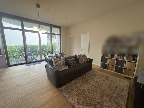 Bright living area with floor-to-ceiling windows onto the terrace